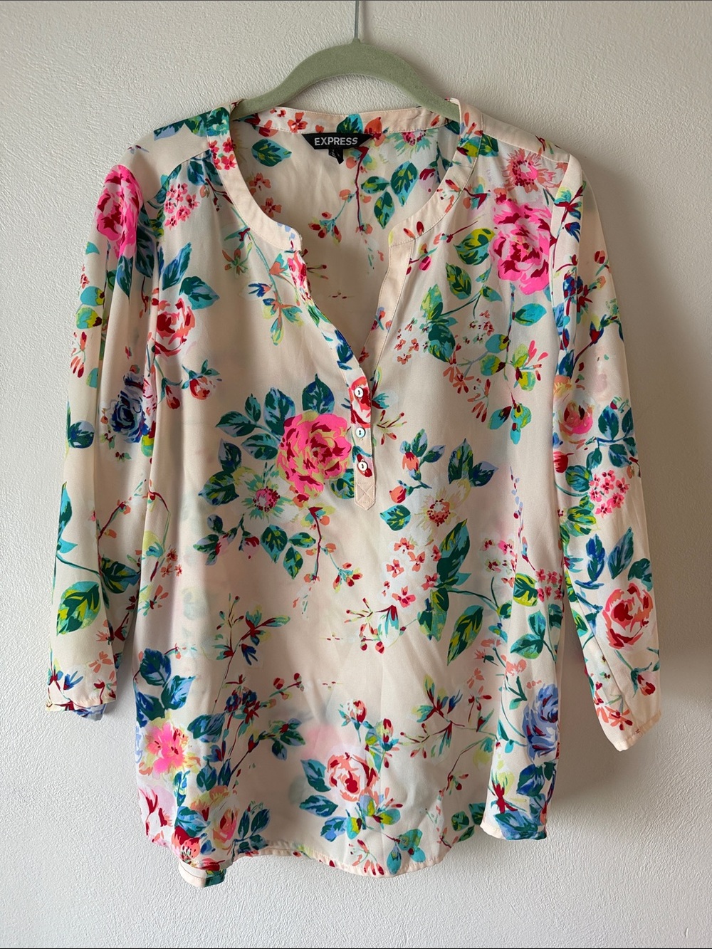 Express women’s blouse 
Size M
Color: cream color with bright floral print.